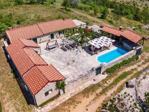 an aerial view of a house with a swimming pool at My Dalmatia - Hilltop Paradise with private pool, sauna and Jacuzzi in Kula Atlagić