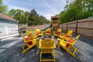 a group of yellow chairs and a playground at Cape Cod heated Pool, Putting Green, Speak Easy, Game room, in Harwich