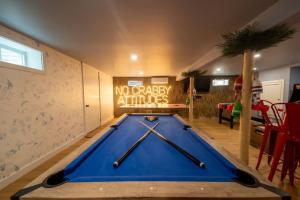a pool table in a room with two paddles on it at Cape Cod heated Pool, Putting Green, Speak Easy, Game room, in Harwich