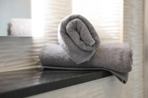 a pile of towels sitting on top of a counter at SOLWO Suites Berlin Charlottenburg in Berlin +37 photos