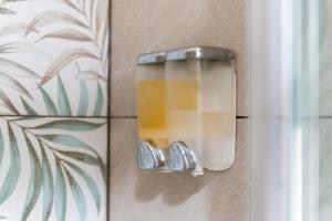 a light on a wall next to a window at Perla Marina Rooms in Realmonte