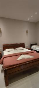 a bedroom with two beds with red sheets at Ecovilla luxury in Pondicherry +45 photos
