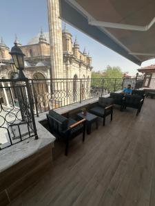 a balcony with couches and a view of a building at ESER PALAS OTELİ in Konya +39 photos