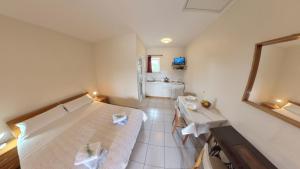 a bedroom with a bed and a table in it at Peaceful studio in avonija in Murine
