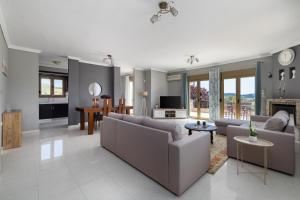 a living room with couches and a dining room at Villa Granero by Booking Kottas in Kassandra +43 photos
