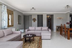 a living room with two couches and a table at Villa Granero by Booking Kottas in Kassandra