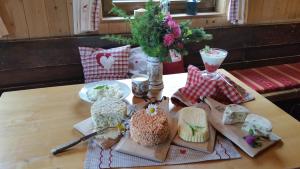 a table with different types of cheeses on it at Branntweineralm in Tamsweg +15 photos