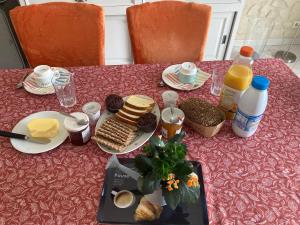 a table with a plate of breakfast food on it at Brigitte Olivier in Teloché