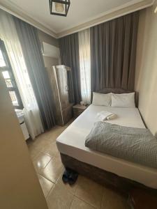 a bedroom with a large bed in a room at ESER PALAS OTELİ in Konya
