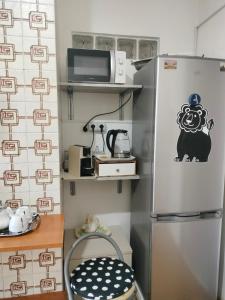 a kitchen with a refrigerator and a microwave at Bougainville Bianco in Quartu SantʼElena