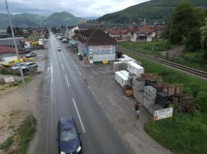 a person walking down a road in a town at Motel MEČE in Bijelo Polje