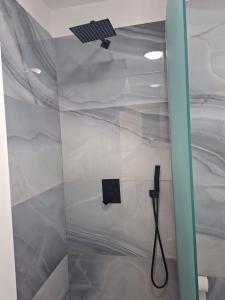 a shower with a cell phone on the ceiling at D&D hotel in Shëngjin +66 photos