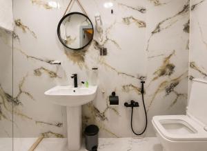 a bathroom with a sink and a mirror at The Destan Hotel and Terrace in Baku +35 photos