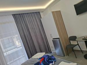 a hotel room with a table and a window at D&D hotel in Shëngjin
