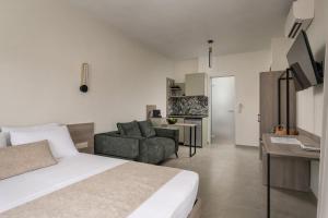 a hotel room with a bed and a living room at KLG Studios and Apartment in Nikiti