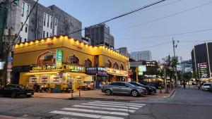a street with cars parked in front of a building at Hotel166 in Suwon