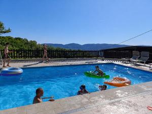 a group of people playing in a swimming pool at Fattoria Cristina Family Duplex with Pool, Panoramic Terrace & Farm Animals - Bilo Rosa in Castelnuovo Magra