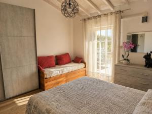 a bedroom with two beds and a window at Fattoria Cristina Family Duplex with Pool, Panoramic Terrace & Farm Animals - Bilo Rosa in Castelnuovo Magra +60 photos