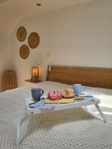 two donuts sitting on a table on a bed at Peniche a Namur - Perle rare - 8 pers in Namur