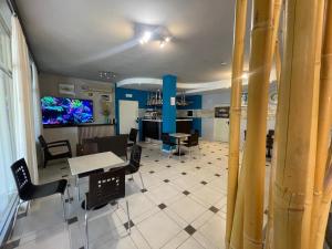 a dining room with tables and chairs and a tv at Hotel Rabay in Brenzone sul Garda