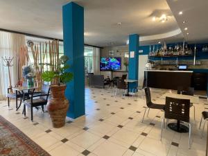 a living room with blue walls and a table and chairs at Hotel Rabay in Brenzone sul Garda