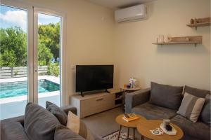 a living room with a couch and a television at Exis Seaview in Vathí