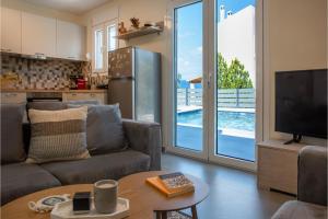 a living room with a couch and a tv at Exis Seaview in Vathí