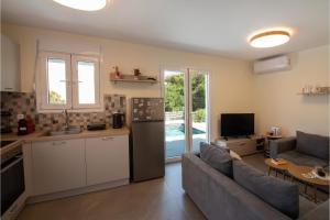 a kitchen and living room with a couch and a refrigerator at Exis Seaview in Vathí