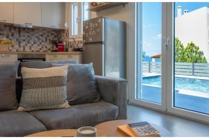 a living room with a couch and a refrigerator at Exis Seaview in Vathí