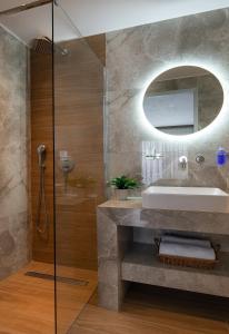 a bathroom with a sink and a mirror at KLG Studios and Apartment in Nikiti +126 photos