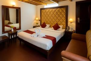 a hotel room with two beds and a mirror at Hotel Morning Lake in Nainital