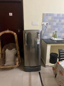 a stainless steel refrigerator in a kitchen with a counter at Ecovilla luxury in Pondicherry