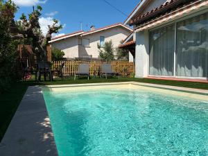 a swimming pool in front of a house at Comme à la maison B and B - 2 chambres et 1 salon in Carcassonne