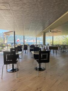 a dining room with tables and chairs with a view at Hotel Rabay in Brenzone sul Garda