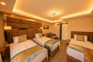 Un pat sau paturi într-o cameră la Kavi Hotel