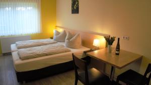 a bedroom with a bed and a table with a table at Wein- Appartements Borth in Bretzfeld