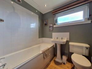 a bathroom with a sink and a toilet and a bath tub at Lyndale in Tobermory +10 photos