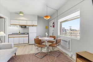 a kitchen and a living room with a table and chairs at Coliseum Ocean Resort in Wildwood Crest