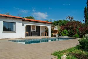 a villa with a swimming pool and a house at Villa Leda - The Guest Wing in Paphos
