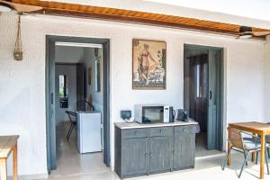 a living room with a tv and a refrigerator at Villa Leda - The Guest Wing in Paphos