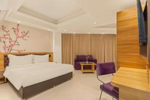 a bedroom with a bed and a desk and a tv at Country Inn Smart Stays, Patna in Patna +23 photos