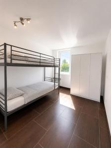a bedroom with two bunk beds and a tile floor at Albert 18 Brussels-charleroi-airport in Charleroi