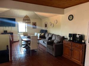 a living room with a couch and a table at Casas do Natureza de Coura in Paredes de Coura +28 photos