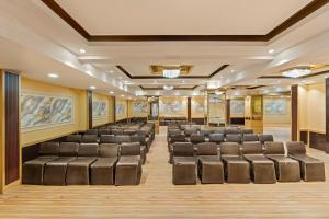 a conference room with chairs and paintings on the walls at Country Inn Smart Stays, Patna in Patna