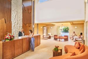 a man and a woman standing at a counter in a lobby at Medina Les Quatre Saisons Aqua Park Resort and Thalasso Djerba in Djerba +104 photos