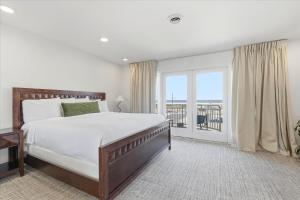 a bedroom with a large bed and a balcony at Coliseum Ocean Resort in Wildwood Crest +52 photos