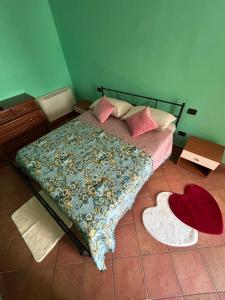 a bedroom with a bed with a blanket on it at Casa Lory in Posta Fibreno