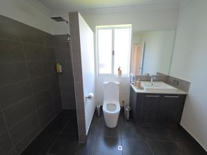 a bathroom with a toilet and a sink at Baldivis Retreat in Baldivis +14 photos