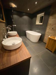 a bathroom with two sinks and a bath tub at Spacious Hemsedal villa with mountain views in Hemsedal +24 photos
