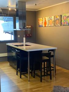 a kitchen with a table and some chairs at Spacious Hemsedal villa with mountain views in Hemsedal